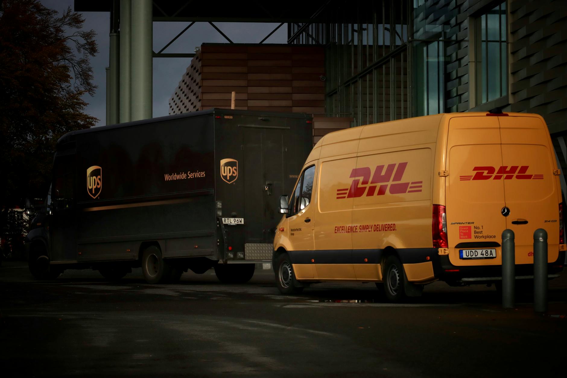 mail delivery trucks parked under building at night