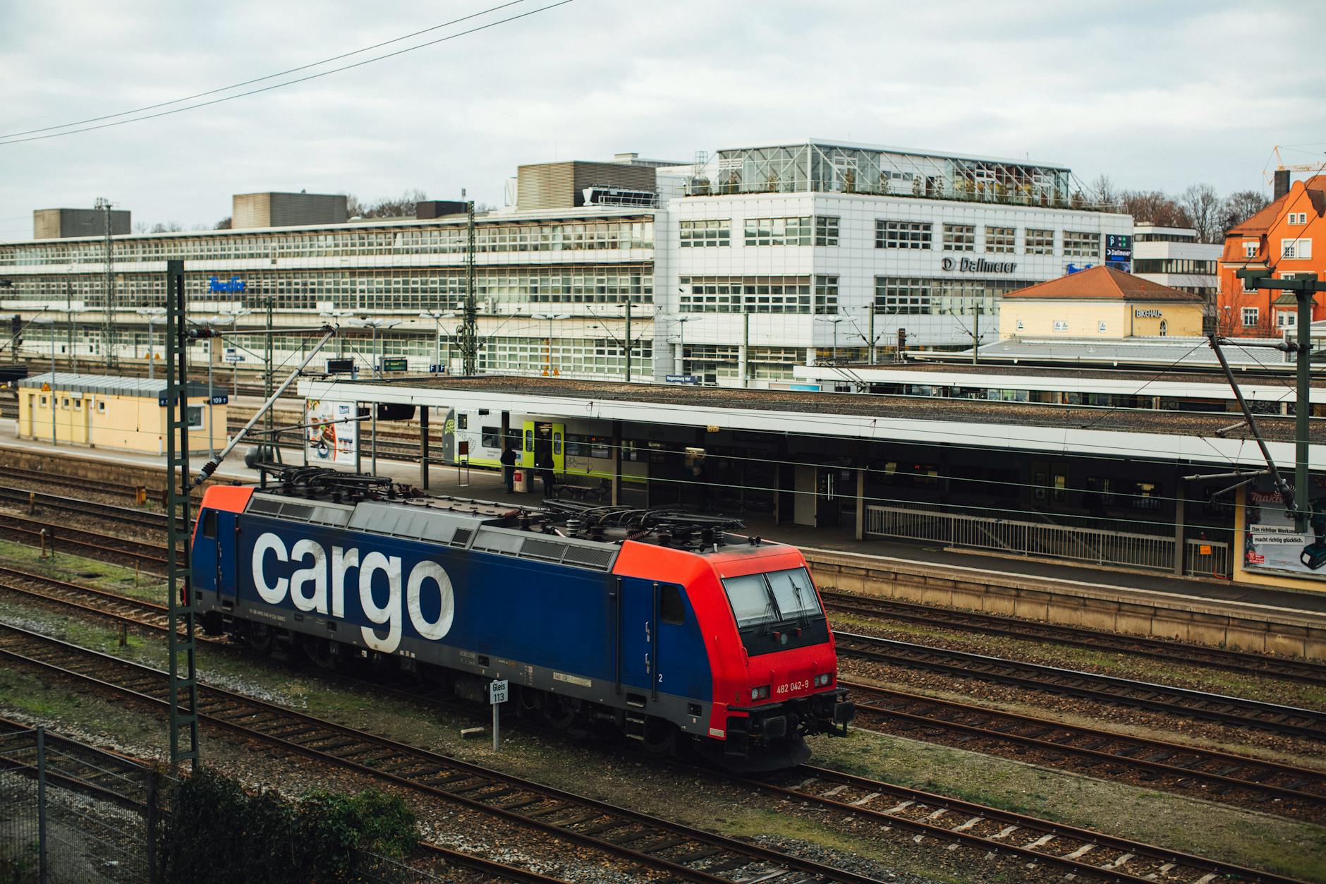 red and blue train on railroads